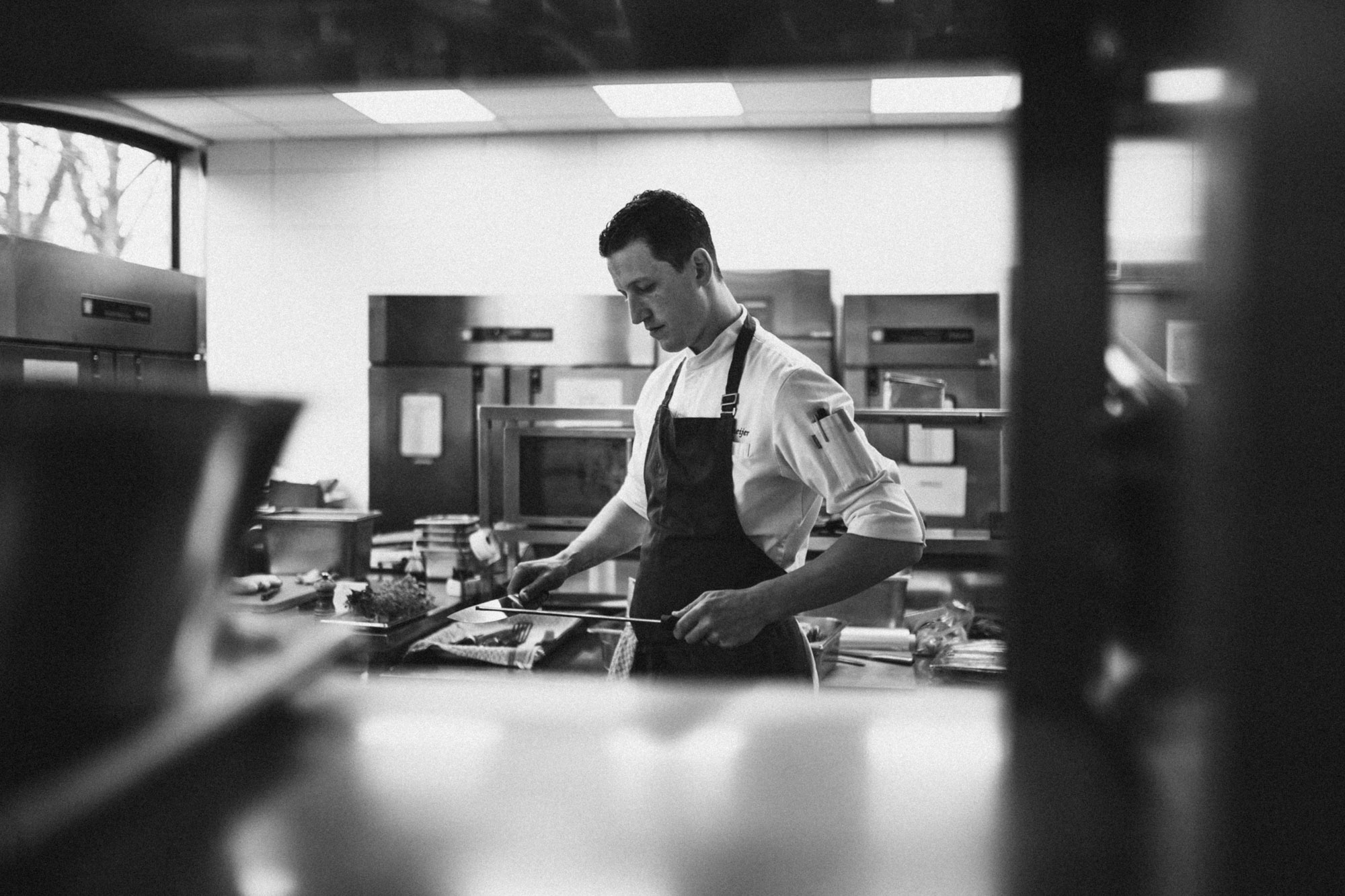 Chef sharpens his knife in the Glashaus restaurant in Cologne.